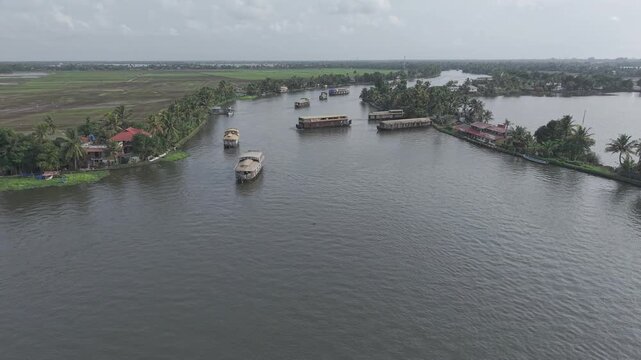Aerial drone view of traditional houseboats on Kerala backwaters, Alappuzha, India.
