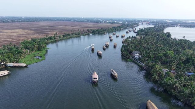 Aerial drone view of traditional houseboats on Kerala backwaters, Alappuzha, India.
