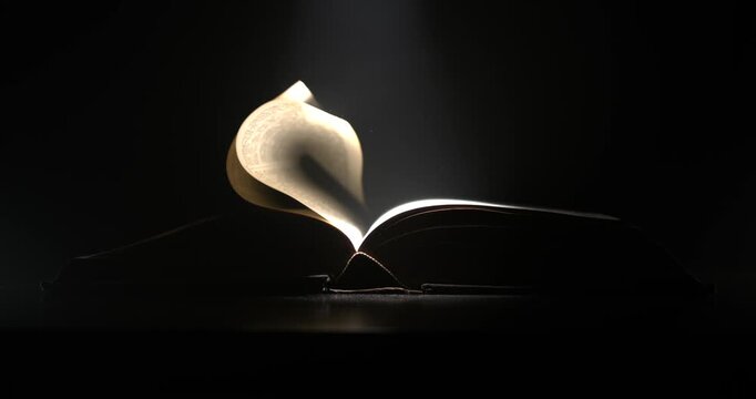 Super Slow Motion Pages Sway With Gentle Elegance Under Light. Book Pages Move Slowly Like Wings Illuminated
