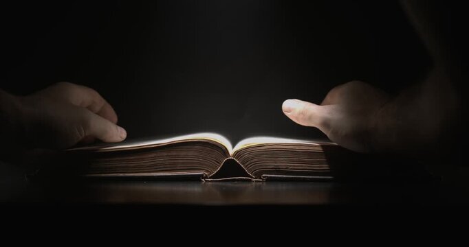Careful Hands Turn Pages Under Soft Light. Subtle Closeup Of Hands Flipping Pages In Calm Illumination