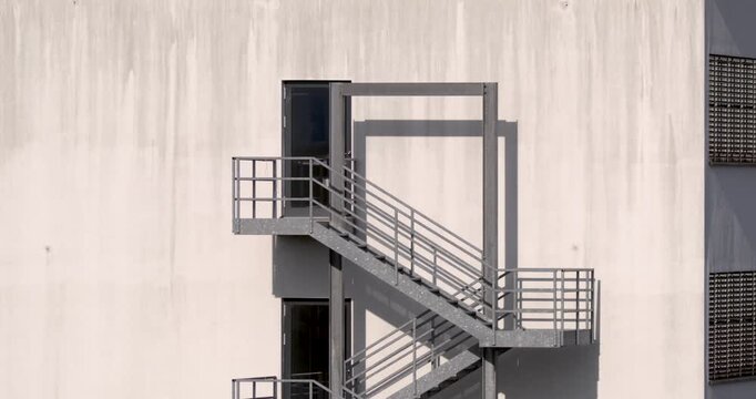 Concrete Staircase With Shadows. Full Fire Escape Structure With Long Shadow Patterns And Urban Feel