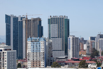 Batumi, Georgia - May 11, 2026: Modern high-rise apartment buildings and construction cranes in a developing city skyline © ipolstock