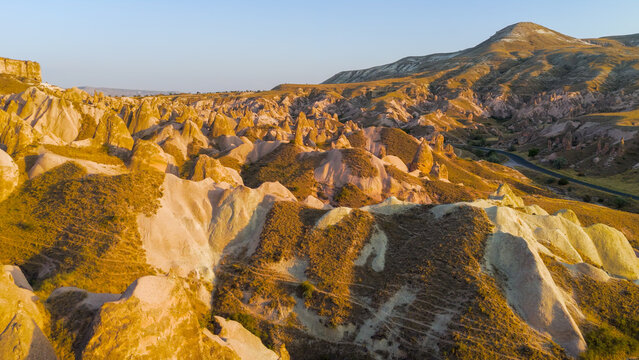 Goreme, Nevsehir, Turkey. Evening drone view of Devrent Valley surreal rock sculptures and fantasy-like formations in warm sunset light.. Aerial View
