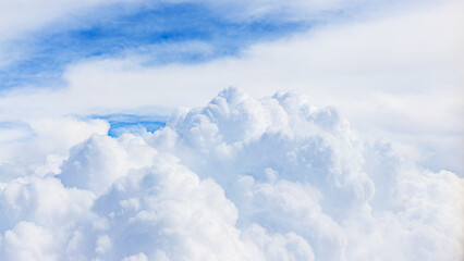 Fototapeta premium White clouds float in blue sky during daytime over open area on a clear day with no visible obstacles