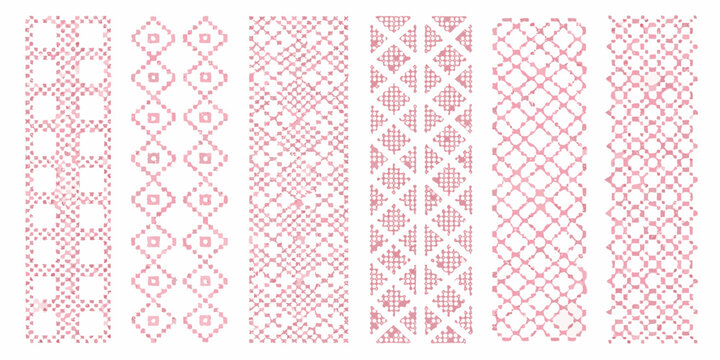Pink cross stitch patterns on a white background