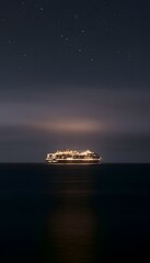 Obraz premium Majestic cruise ship sails a tranquil dark ocean beneath a breathtaking starlit sky