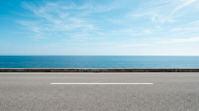 Coastal asphalt road with the sea and blue sky in the background.