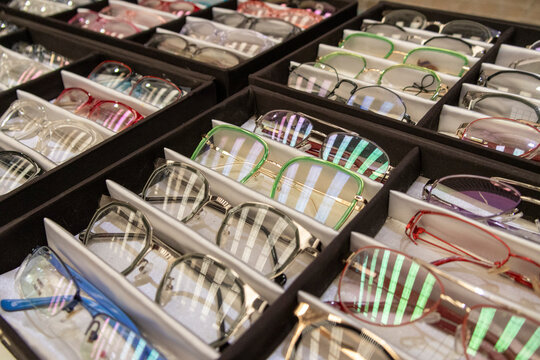 Close-up of multiple eyeglasses frames arranged side by side.
