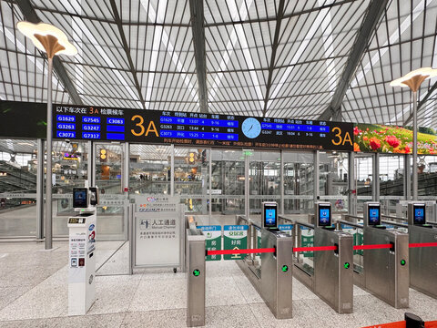 Shanghai railway station, China, 3 April 2026 - Gate 3A departure hall with automated ticket barriers, digital departure boards, and facial recognition gates at a modern high-speed rail terminal.