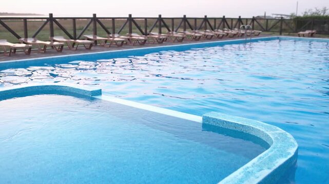 Top view of swimming pool with clear water on vacation on sunset background