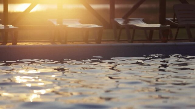 Top view of swimming pool with clear water on vacation on sunset background