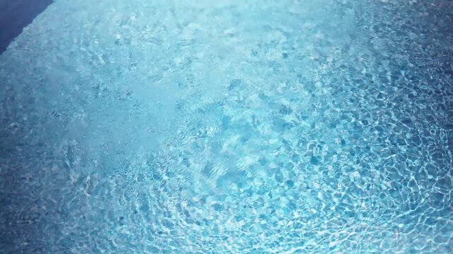 Pure blue water in pool with light reflections