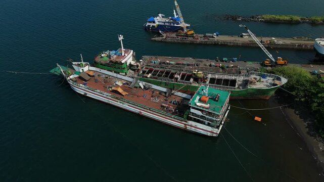 Port scene shows large ship anchored with green deck. Ideal for business concept usage and urban development