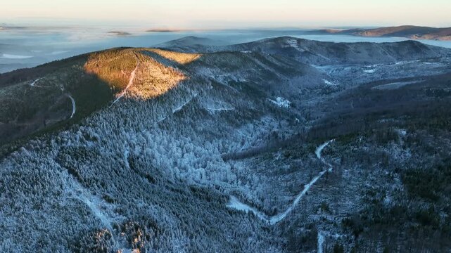 First Golden Sunlight on Winter Mountain Peak