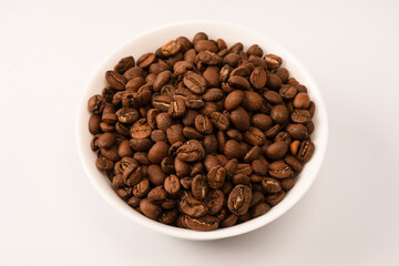 Fototapeta premium Coffee beans on a white background. Top view. Coffee beans texture.