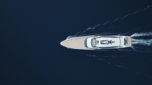 aerial drone nadir view of superyacht and orange tender boat in Bay of Kotor from above, Montenegro
