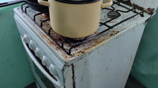 Shrimp boiling and bubbling in pot on old dirty gas stove
