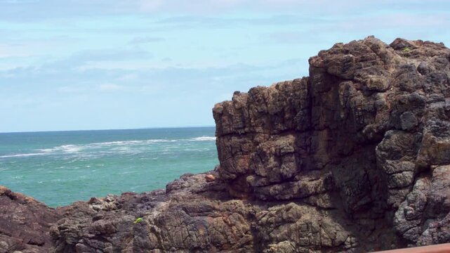 Medium shot of the powerful Kiama Blowhole erupting with a massive water spray in front of the camera
