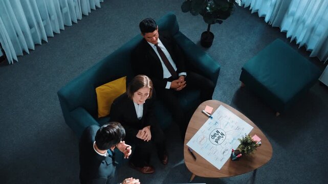 Top view of smart businessman present strategy to group of investor by using mind map brainstorm marketing idea at table with sticky notes and marker at meeting room. Creative workplace. Directorate.
