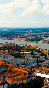Vertical video. Gothenburg, Sweden. River Gota-Alv. Panoramic view of the central part of the city. Summer day. Cloudy weather. Drone footage. Rich colors