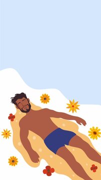 Man sunbathing and relaxing on sandy beach with flowers