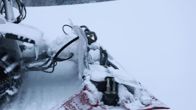 Maintenanceready Groomer On Snowy Ground. Vehicle With Rugged Chassis Parked In Tranquil Forest Setting