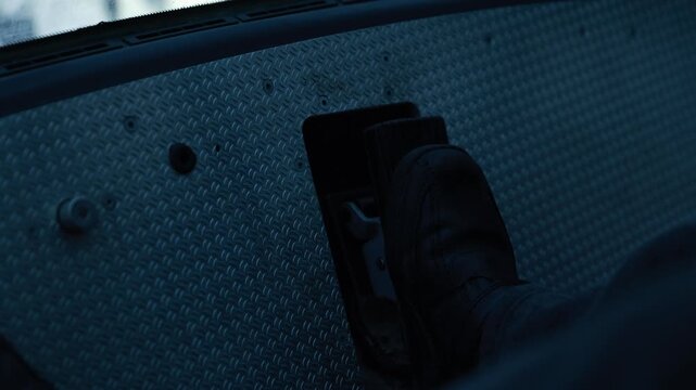 Noirstyle Image Capturing Worker Handling Equipment On Rugged Metallic Panel Under Winter Light