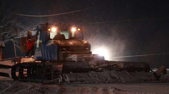 Engine Inspection Scene. Calm Night As Operator Inspects Machinery Detail Near Snow Cannon And Frost