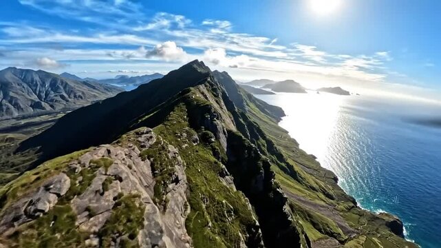 Epic aerial view of a mountain ridge overlooking the ocean under a bright sunny sky with a few clouds