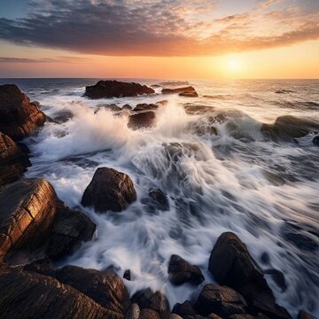 dramatic ocean waves crashing on rocky coastline at sunset l