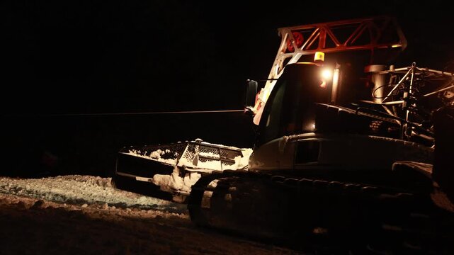 Amber Lights Highlight Freshly Compacted Snow And Precise Grooming On Rugged Terrain At Night