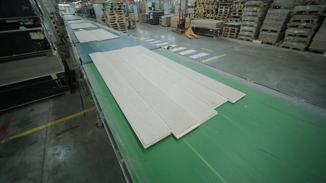 Close-up of an automated production line with timber slats in motion within a modern wood processing facility