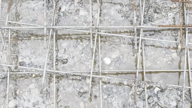 water fill a concrete form with rebar during a storm