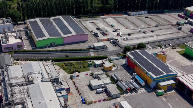 Drone view of an energy intensive pharmaceutical and chemical industrial complex in Europe. Large scale production facilities with high power demand infrastructure and continuous processing systems.