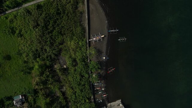 Drone shot captures a serene lake bordered by thick forest. Ideal tropical paradise and travel destination.