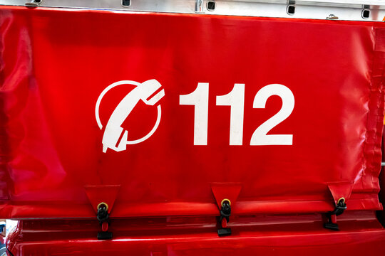 Emergency Number 112 on Firefighter Vehicle Cover, Close up photograph of emergency number 112 displayed on a red protective cover mounted on a firefighter or rescue vehicle. Symbolic image for emerge