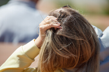 Fototapeta premium Woman gently touches her hair