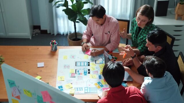 Top down view of business team putting hand together while discussing about Ux Ui design for mobile phone at boardroom. Close up of marketing team making stack of hand and clapping hand. Convocation.