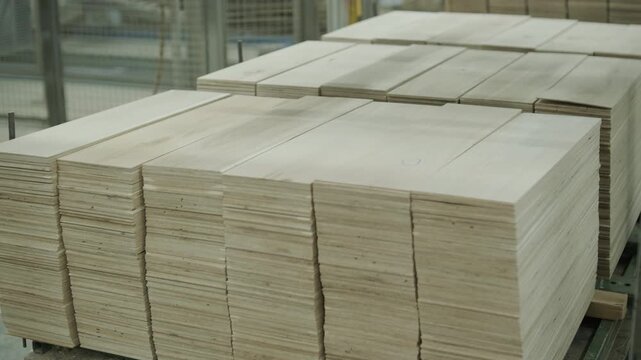 Close-up of an automated production line with timber slats in motion within a modern wood processing facility