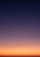 Obraz premium Vibrant Sunset Sky Gradient with Deep Purple and Bright Orange Colors for Minimalist Background Design