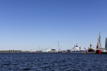 Fototapeta premium waterfront city view, industrial harbor by the water, Scandinavian waterfront skyline, blue sky over the harbor