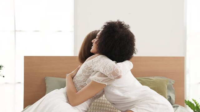 Romantic couple smiling together on bedroom bed