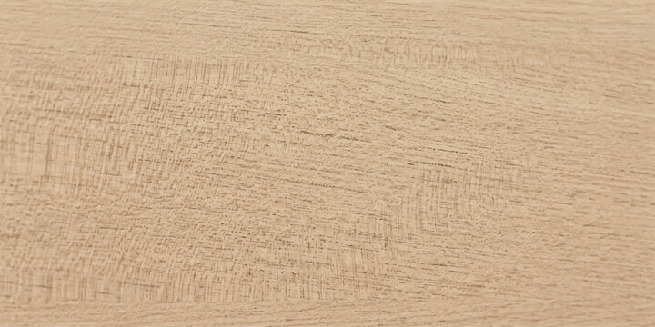 A close-up shot showcases the fine grain and natural texture of light brown wood, highlighting its organic beauty and subtle patterns.