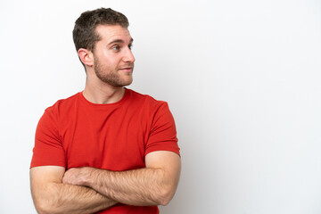 Obraz premium Young caucasian man isolated on white background looking to the side