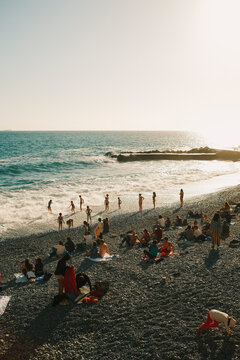 Children playing at the beach during sunset in Camogli