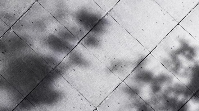 Abstract geometric pattern of concrete tiles with soft shadows and sun lights..