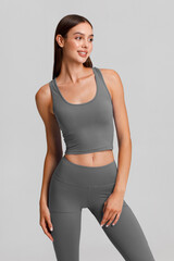 Obraz premium Athletic girl on the gray background. Fitness woman
