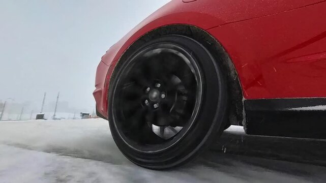 Close-up of a sports car wheel during drifting. 