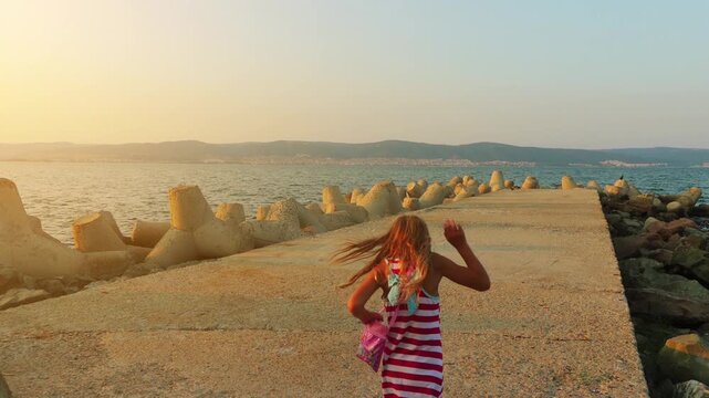 Two little beautiful girls walk in Nesebar, Bulgaria