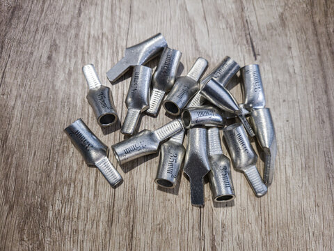 Metal cable lugs on wooden surface